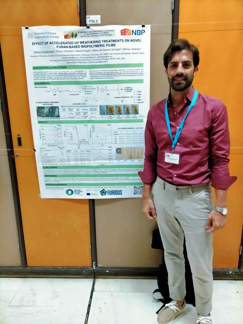 Ignacio Solaberrieta posing in front of his poster.